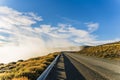 Perspective view of road trip on asphalt road with beautiful sea of fog and nature golden yellow grass and mountains in autumn in