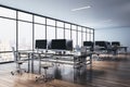 Perspective view on stylish minimalistic design workspaces with modern computers on wooden floor and city view from big window. 3D Royalty Free Stock Photo