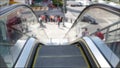 Perspective view thru escalator, defocused unrecognizable group of people on road intersection crosswalk on Strip of Las Vegas,