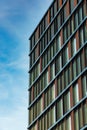 Perspective view to facade of modern corporate building with reflections in windows Royalty Free Stock Photo