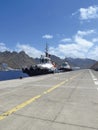 Perspective view of tug boat docked at port dock. Professional boat for port work. Large tugboat berth in the port. Nautical