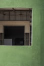 Perspective view of unfinished interior door and wall structure in window frame on curve green wall of modern house Royalty Free Stock Photo