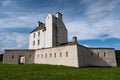 Perspective view of white Corgarff Castle at nice sunny afternoon with blue sky