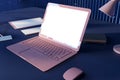 Perspective view on white screen with space for your logo or text of modern pink laptop screen on dark work table with notebooks, Royalty Free Stock Photo