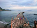 Perspective view of a wooden pier mole at sea. Wooden bridge in spring time with blue sky. Place for fishing with pier Royalty Free Stock Photo