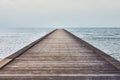 Perspective view of a wooden pier in tropical sea Royalty Free Stock Photo