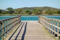 Perspective view of a wooden pier on tropical sea bay at sunny day Royalty Free Stock Photo