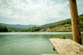 Perspective Wooden board empty table in front of nature background with mountain and lake. Royalty Free Stock Photo