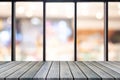 Perspective wooden board empty table on top over blurred coffee shop background, can be used mock up for display of product or Royalty Free Stock Photo