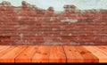 perspective wooden board over blurred brown brick wall Royalty Free Stock Photo