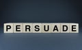 Persuade. The cubes form the word Persuade