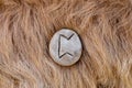 Perth Nordic stone rune on animal fur. Letter Peoro of the Viking alphabet