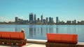 Perth, swan river and tourist on park bench Royalty Free Stock Photo