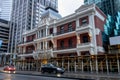 Historical building at Willam Street and St Georges Terrace with hotel under constructions during rainy day