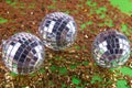 Perty shining mirror disco balls lay on golden sequins background Royalty Free Stock Photo