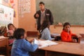 Peru Ayacucho children in a poor school classroom sitting in traditional clothing