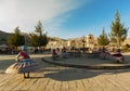 Peru, Chivay, joung girls dancing in traditional dresses around a fountain on the village square Royalty Free Stock Photo