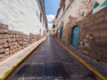 Colonial style street in Cuzco stone walls blue doors