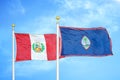 Peru and Guam two flags on flagpoles and blue sky