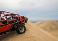 Buggy and sand dunes view from the top of a dune