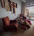 Colorful chairs and decor inside room at Selina hostel, pile of cushions on the floor