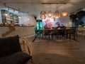 Modern decorated cafe, with bar top and wood lamps hanging from ceiling inside of Selina Hostel