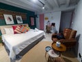 Modern looking hostel room interior, decorated with bright colors and small tables