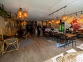 Small cafeteria with modern looking decoration, wood lamps hanging from ceiling