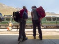 Backpacker couple ready to board train to Machu Picchu Royalty Free Stock Photo