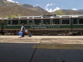 Passenger waiting to board Machupicchu train mountains under the blue sky