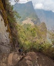 Tourist climbs up the steep stairs at Waynapicchu mountain trail