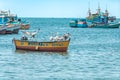 Peru - September 21, 2022: A pelican flies over the ocean near fishing boats Royalty Free Stock Photo