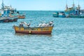 Peru - September 21, 2022: A pelican flies over the ocean near fishing boats Royalty Free Stock Photo