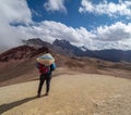 Native in colorful clothes enjoys scenery, andes mountain range