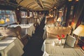 The luxury wooden decoration with comfortable sofas and fancy table lamps of the Perurail Titicaca train.
