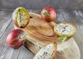 Peruvian apple cactus fruits whole and cut on wooden stand on gray board. Scientific name Cereus repandus