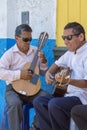 Peruvian blind musicians playing guitar outside, Trujillo