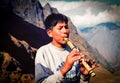 Boy playing flute at the Inca trail in Peru Royalty Free Stock Photo