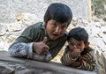 Peruvian boys at the Maras salt evaporation ponds in Peru.