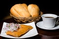 Peruvian breakfast, popular Peruvian tamale with onion sauce, breads and a cup of coffee on a table.