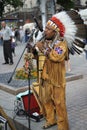 Peruvian busker, street musician, in national clothes playing the native wind instrument on a street. Royalty Free Stock Photo