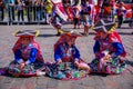 Peruvian children in colorful traditional costumes during a religious ceremony of Inti Raymi