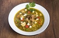 Peruvian cilantro chicken soup or Aguadito de Pollo with yukon gold potatoes corn on the cob and lime slice