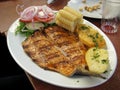 Peruvian dish - fried fish fillet with vegetables, onion, corn, boiled potatoes Royalty Free Stock Photo