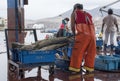 Peruvian fisherman in a cuttlefish stall in Pucusana pier in a cloudy morning in tourist town of Pucusana close to Lima.