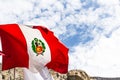 Peruvian flag , blowing in the wind with blue sky