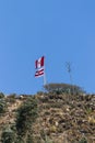 Peruvian flag and Mancos flag hanging on the flagpole at the top of a hillLocated in Mancos, Ancash - Peru.