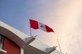 Peruvian flag waving on top of a building. Concept of countries and patriotism.