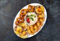 PERUVIAN FOOD. Piqueo caliente. Hot seafood platter fried shrimps, squid rings and baked scallops with sauce Royalty Free Stock Photo