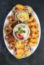 PERUVIAN FOOD. Piqueo caliente. Hot seafood platter fried shrimps, squid rings and baked scallops with sauce Royalty Free Stock Photo